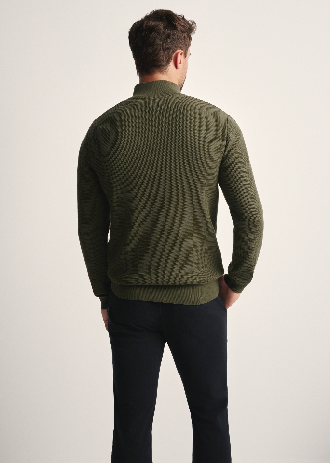 Pánsky khaki sveter na zips SWEMT-0167-55(Z25), pohľad na modelku zozadu. Viditeľná polovica siluety.