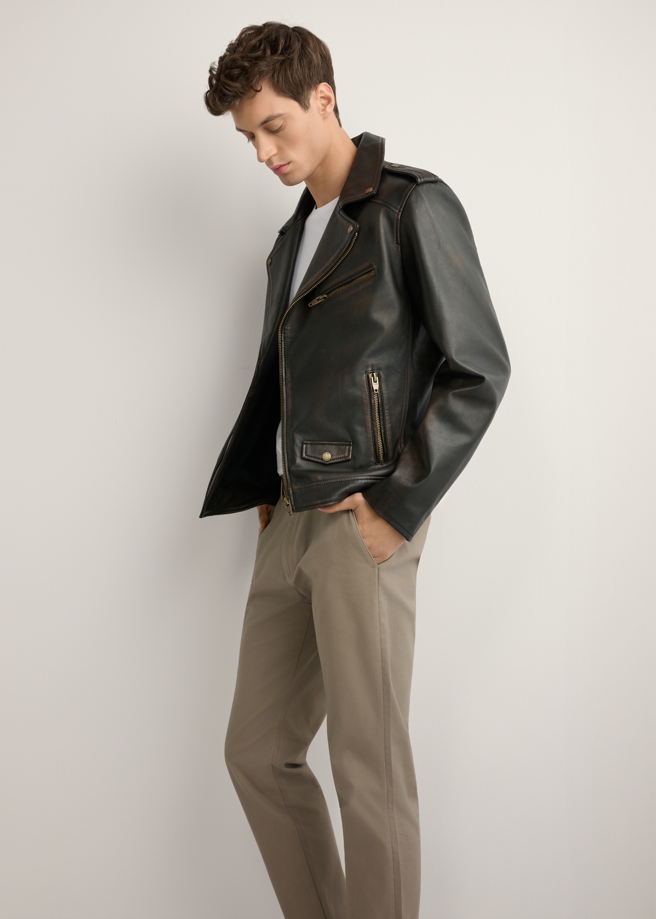 Pánska kožená motorkárska bunda KURMS-0395-99(W26) - bočný pohľad na produkt, na modeli, na svetlom pozadí. Viditeľná celá silueta.