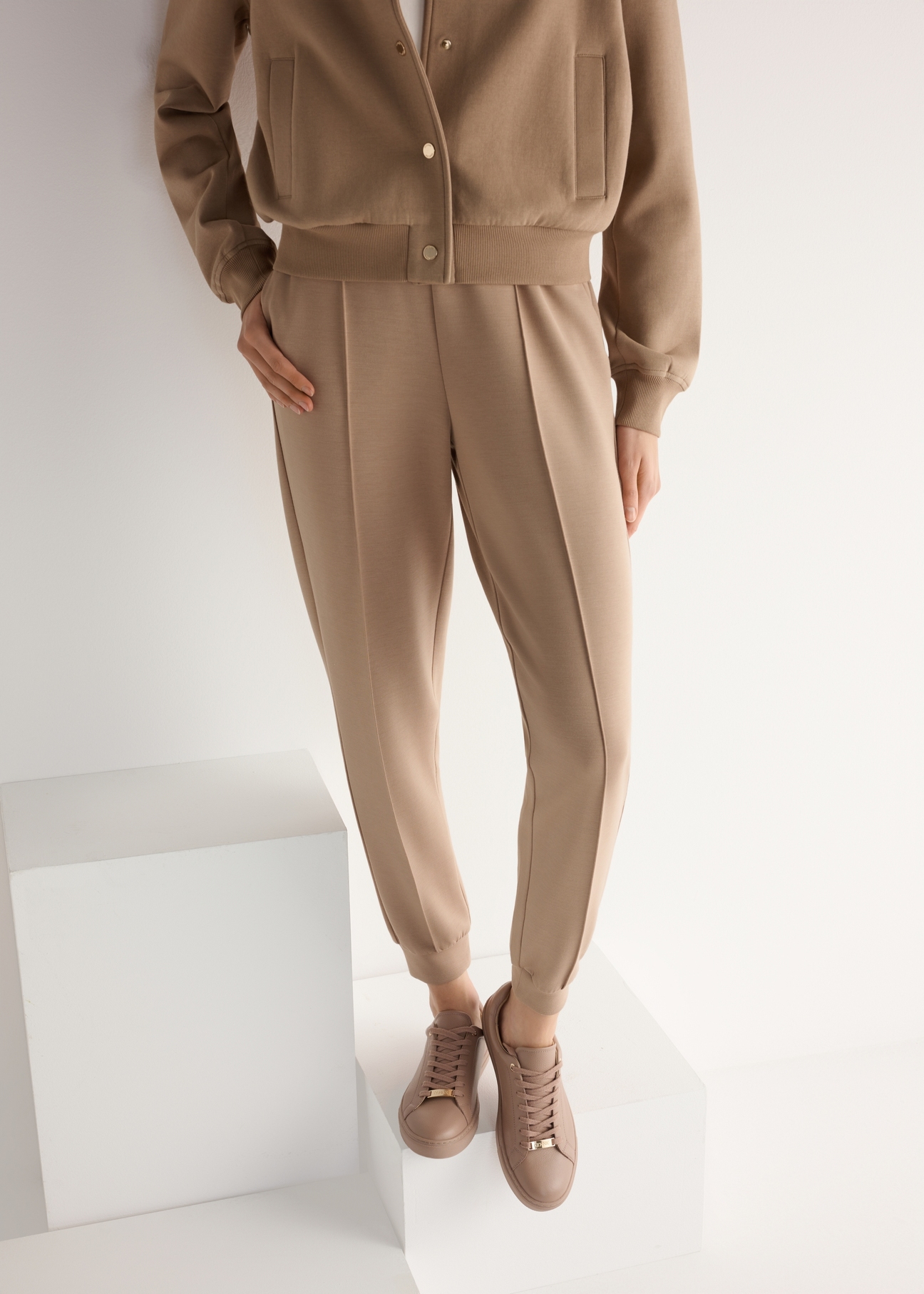 Dámske ružové kožené tenisky BUTYD-1068-5D(W26), pohľad na produkt spredu na modelke, viditeľná polovica siluety.