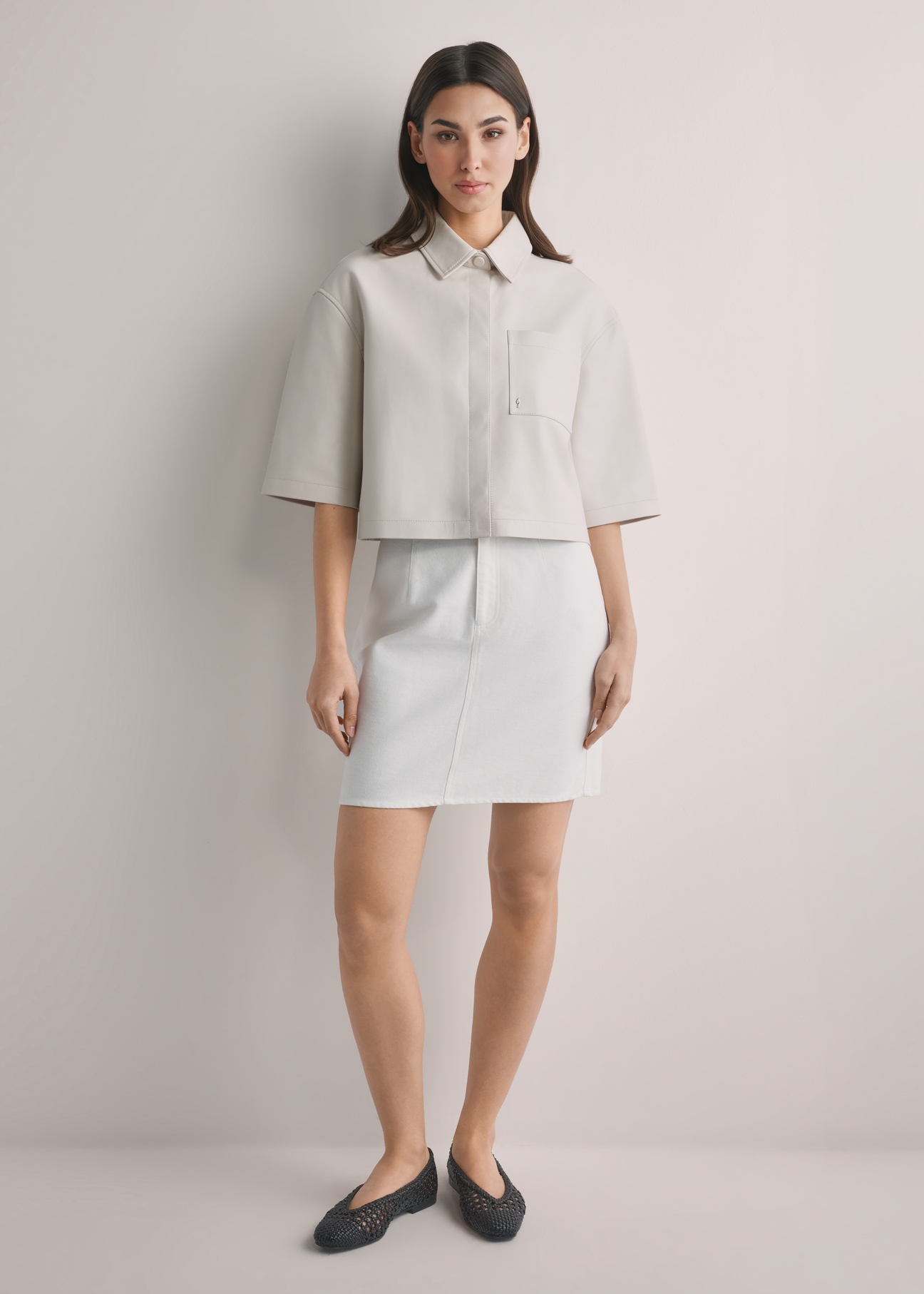 Krémová džínsová minisukňa SPCDT-0126-0B(W26), pohľad spredu na produkt na modelke. Viditeľné celé telo.