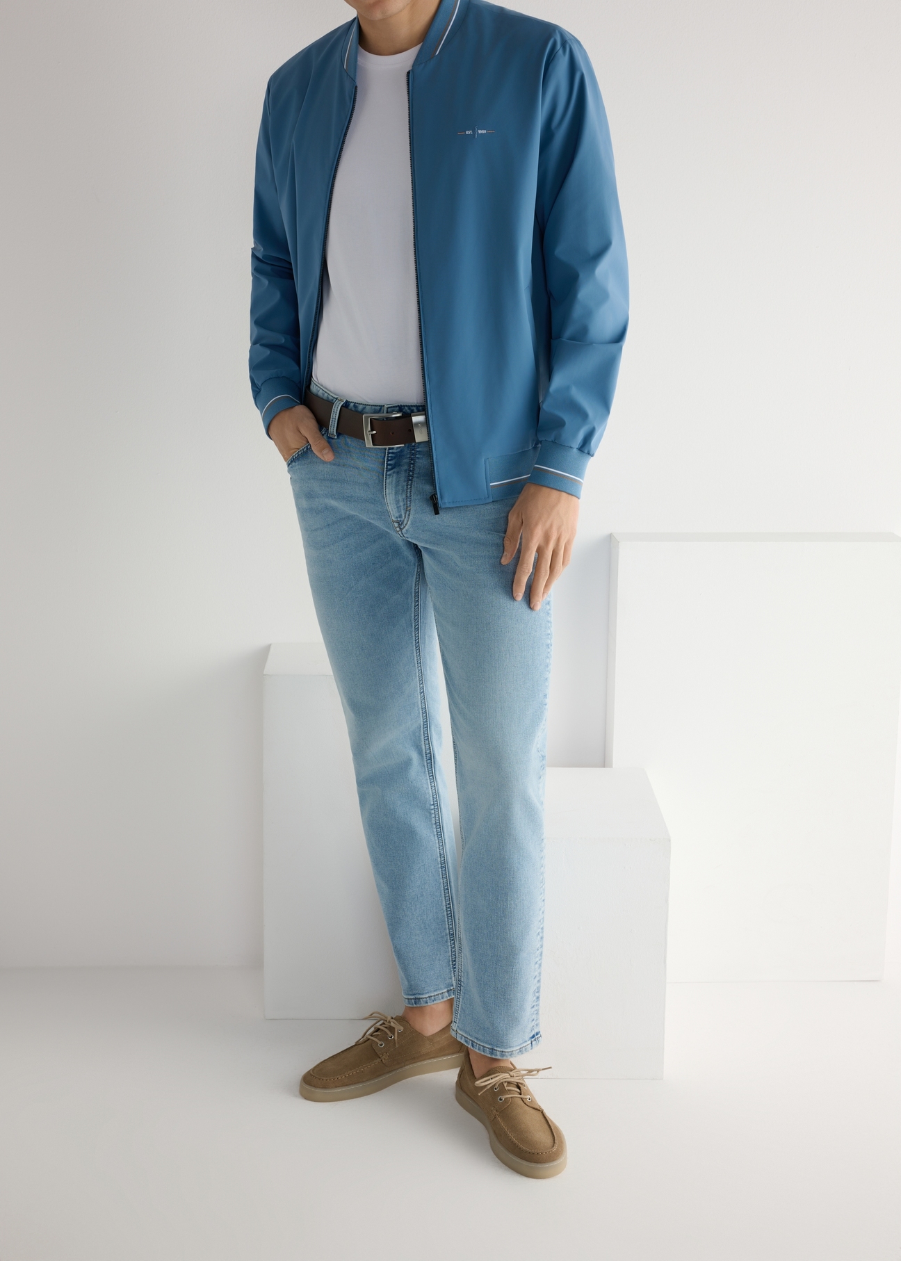 Pánske kožené topánky v chladnej béžovej farbe BUTYM-0533-1K(W26), pohľad na produkt na nohách modelky, na svetlom pozadí.