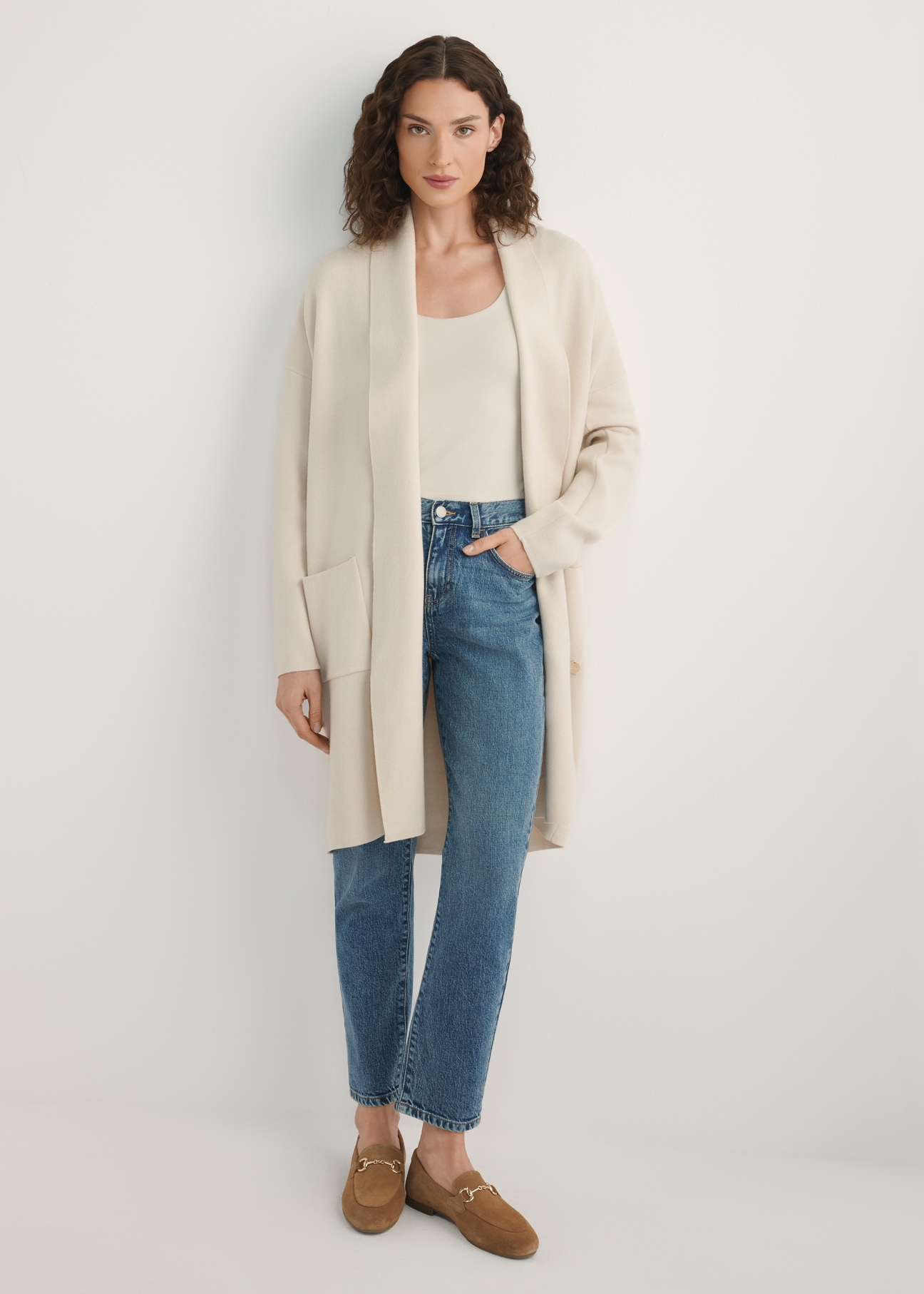 Dámsky béžový kardigan KARDT-0041-1A(W26), pohľad spredu na modelku. Viditeľná polovica siluety.