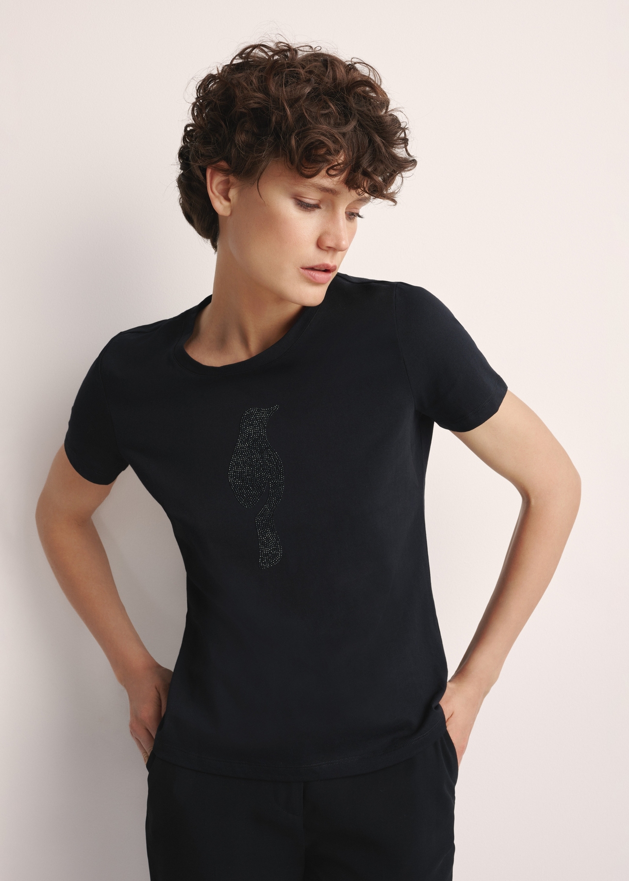 Čierne dámske tričko s logom TSHDT-0148-99(Z25), pohľad spredu na produkt na modelke. Viditeľná polovica siluety.