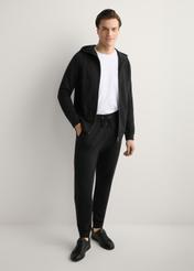 Pánske čierne tepláky SPOMT-0017-99(W26), pohľad na produkt spredu na modeli, viditeľná je celá silueta.