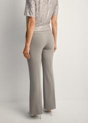 Dámske sivé nohavice SPODT-0113-91(Z25), pohľad na výrobok zozadu na modelke. Viditeľná polovica siluety.