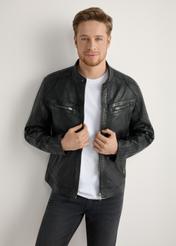 Pánska čierna kožená bunda KURMS-0397-99(W26) - pohľad spredu na produkt, na modelke, na svetlom pozadí. Viditeľná silueta po kolená.