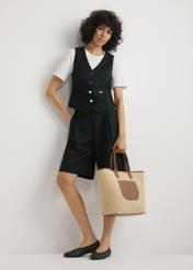 Veľká dámska slamená kabelka TOREC-1229-1E(W26), pohľad na produkt držaný v ruke modelky, na svetlom pozadí. Viditeľná je celá silueta.