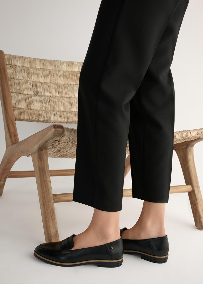 Dámske čierne kožené mokasíny BUTYD-1067-99(W25), bočný pohľad na produkt na modelke, viditeľná polovica siluety.